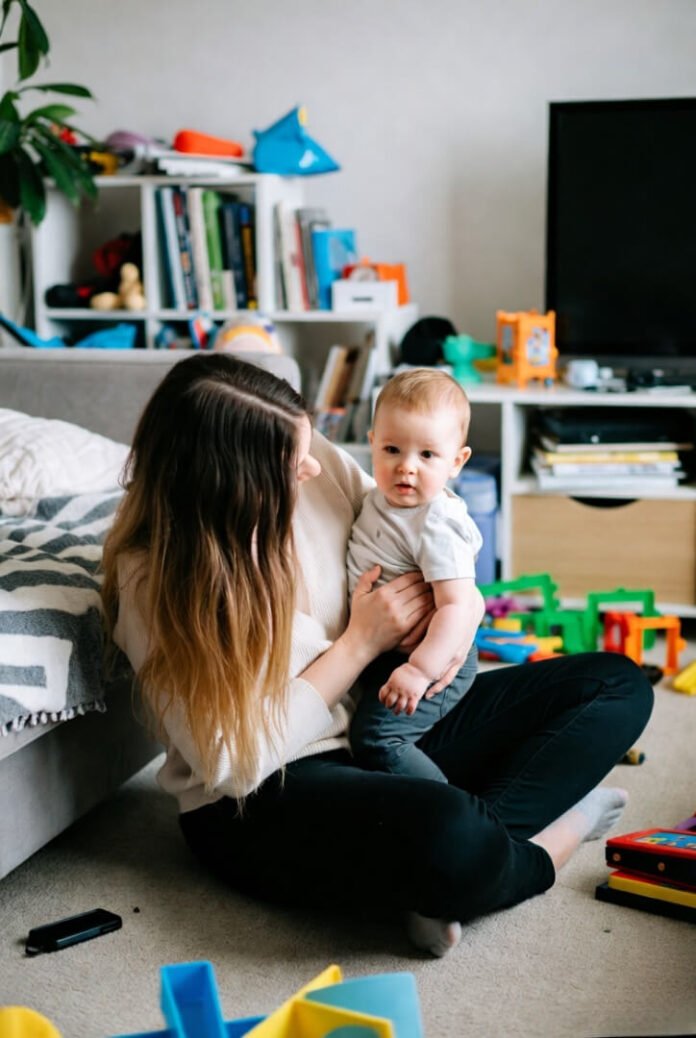 Tired mom’s tender floor playtime with baby Tired mom’s tender floor playtime with baby