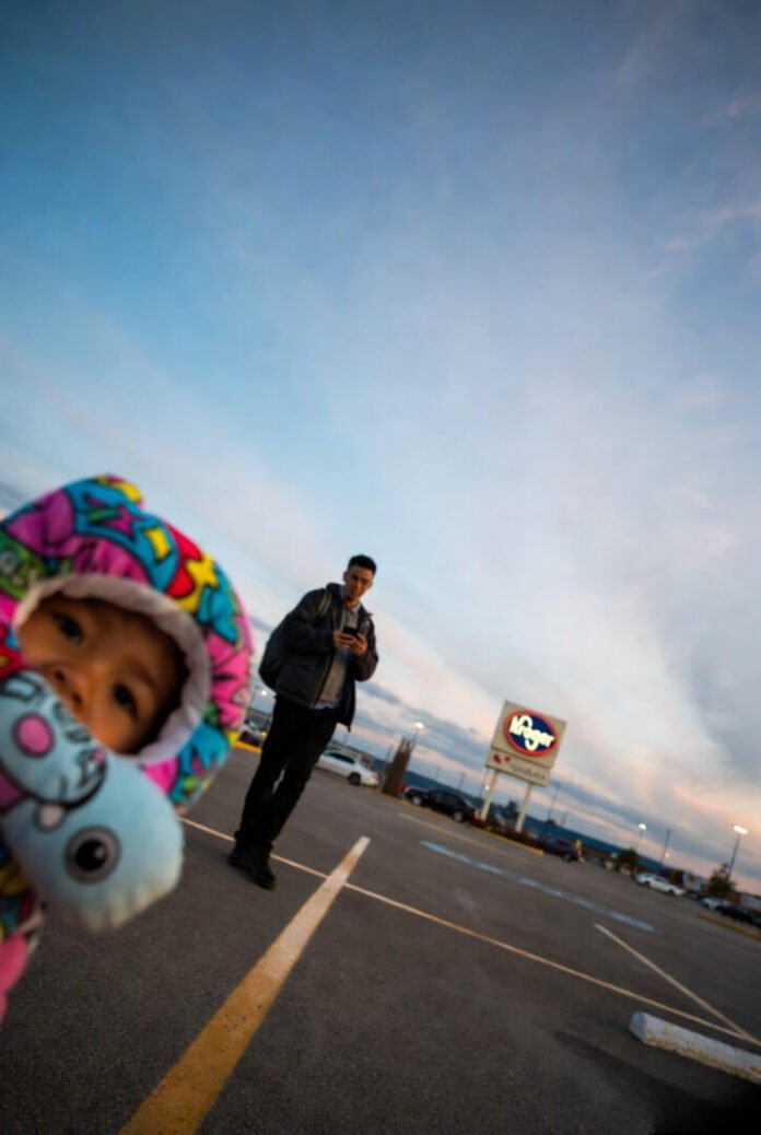 Tilted Kroger parking lot selfie, kid’s face hidden by colorful pillow pet, one eye peeking out. Tilted Kroger parking lot selfie, kid’s face hidden by colorful pillow pet, one eye peeking out.