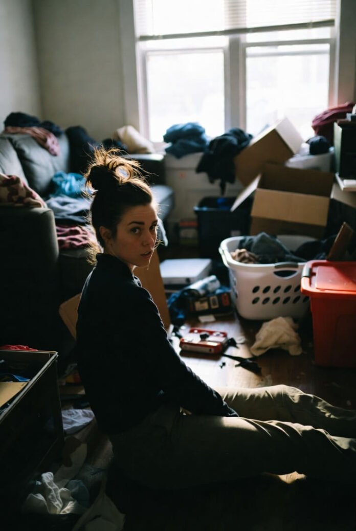 Sitting on the floor, messy bun unraveling in cozy chaos Sitting on the floor, messy bun unraveling in cozy chaos