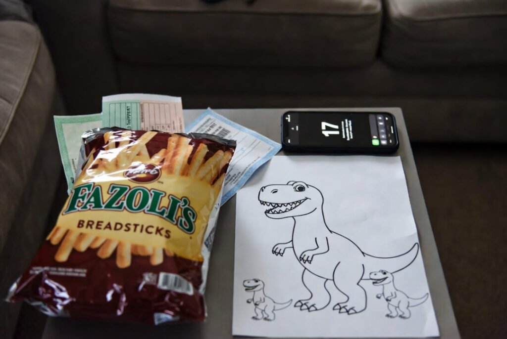 Fazoli’s bag, unfinished dinosaur family drawing, two support payment checks, phone with 17 missed messages.
