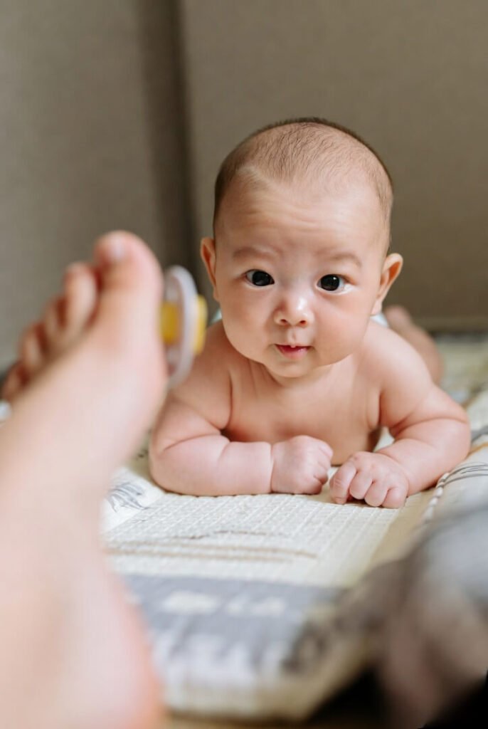 Tummy time struggle, lifeline pacifier nearby